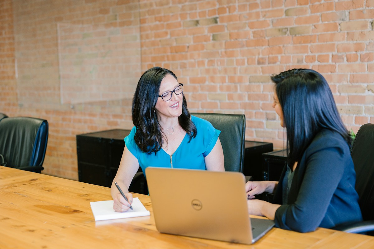 Two people in a business conversation; illustrative stock photograph