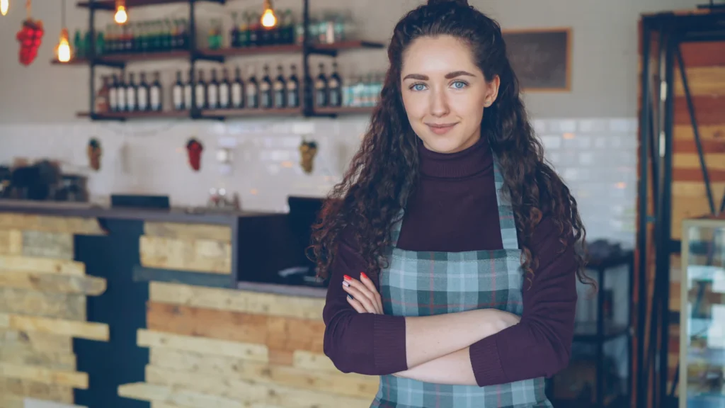 Small business owner smiling in her coffee shop
